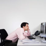 Bored Male Office Worker At Desk